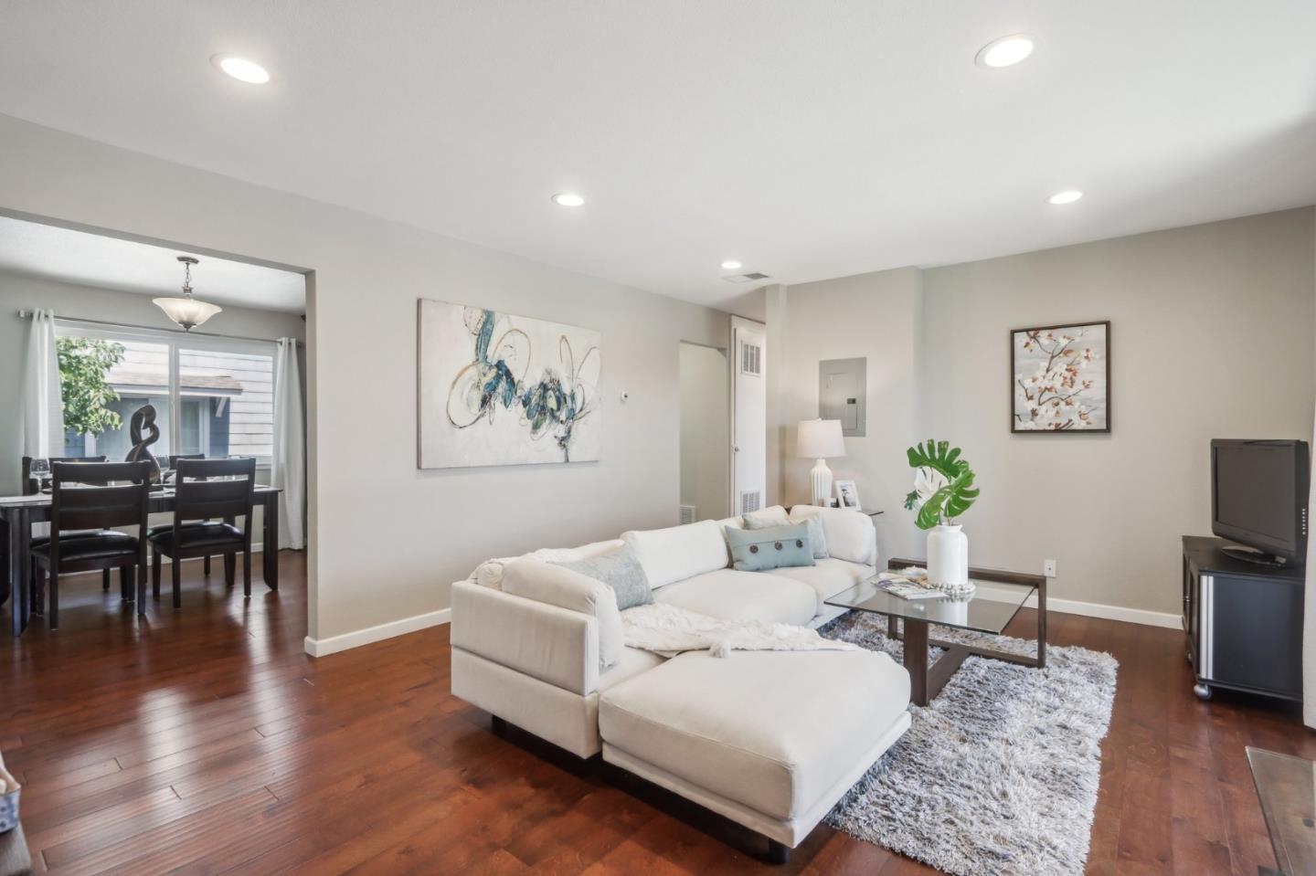 a living room with furniture and wooden floor