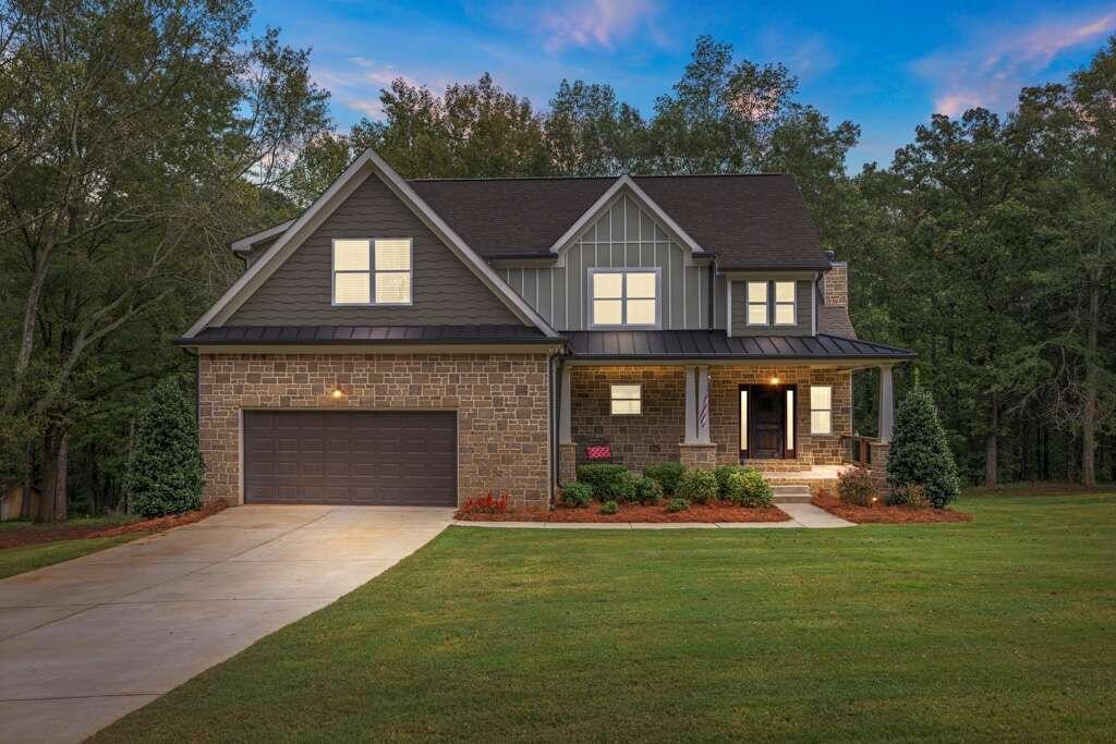 a front view of a house with a yard and garage