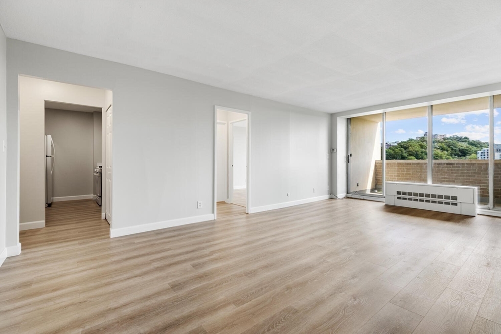 a view of a room with wooden floor and window