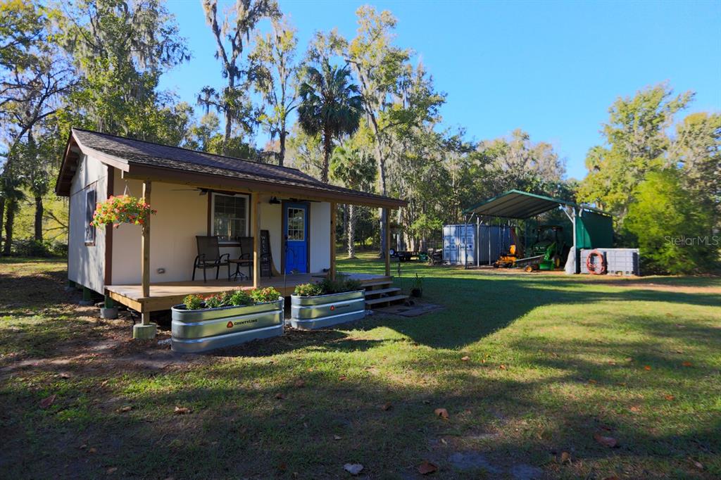 a front view of a house with swimming pool having outdoor seating