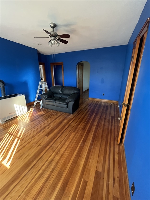 a room with wooden floor pool table and chair