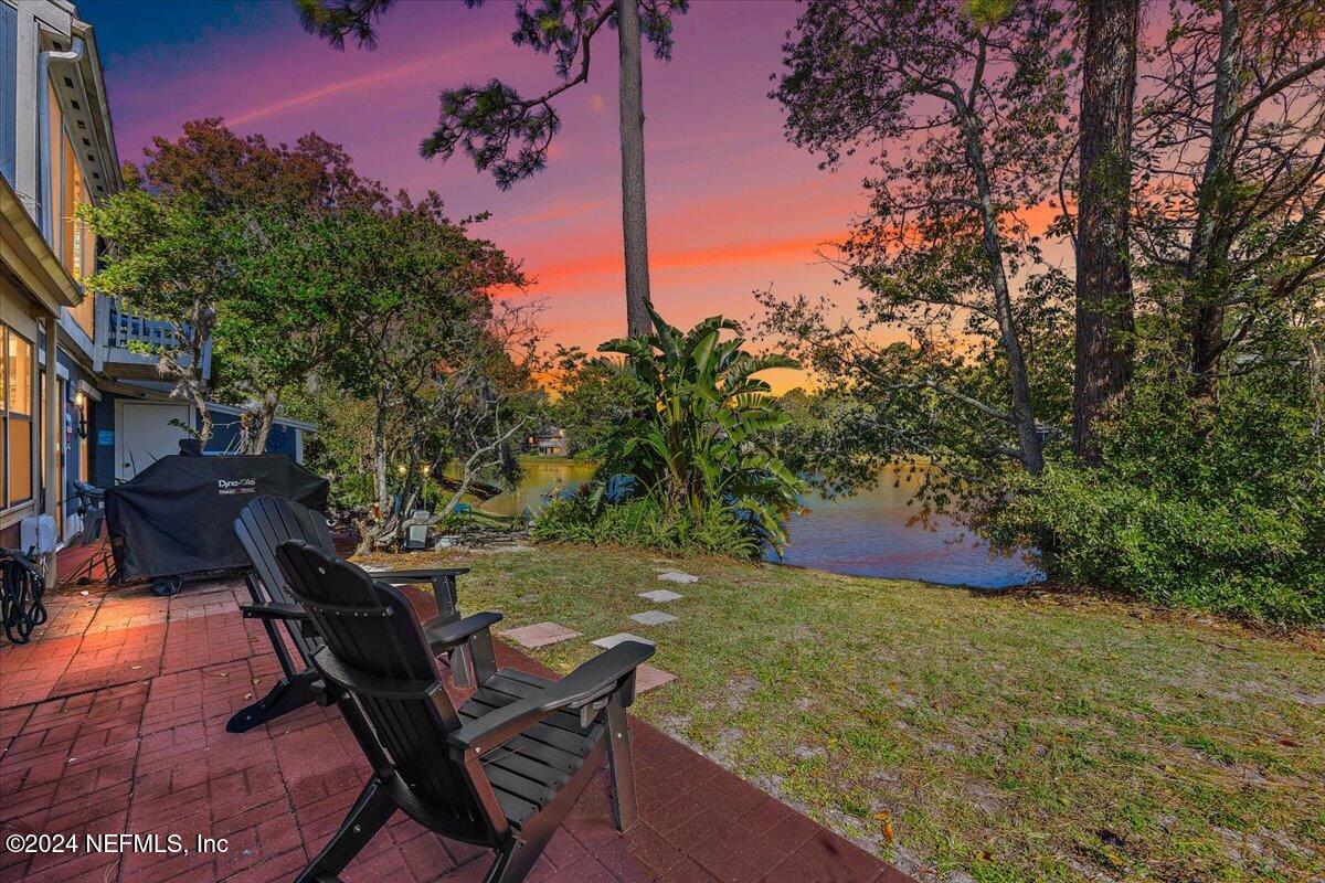 a view of a backyard with sitting area