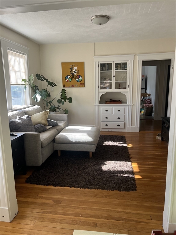 a living room with furniture and a wooden floor