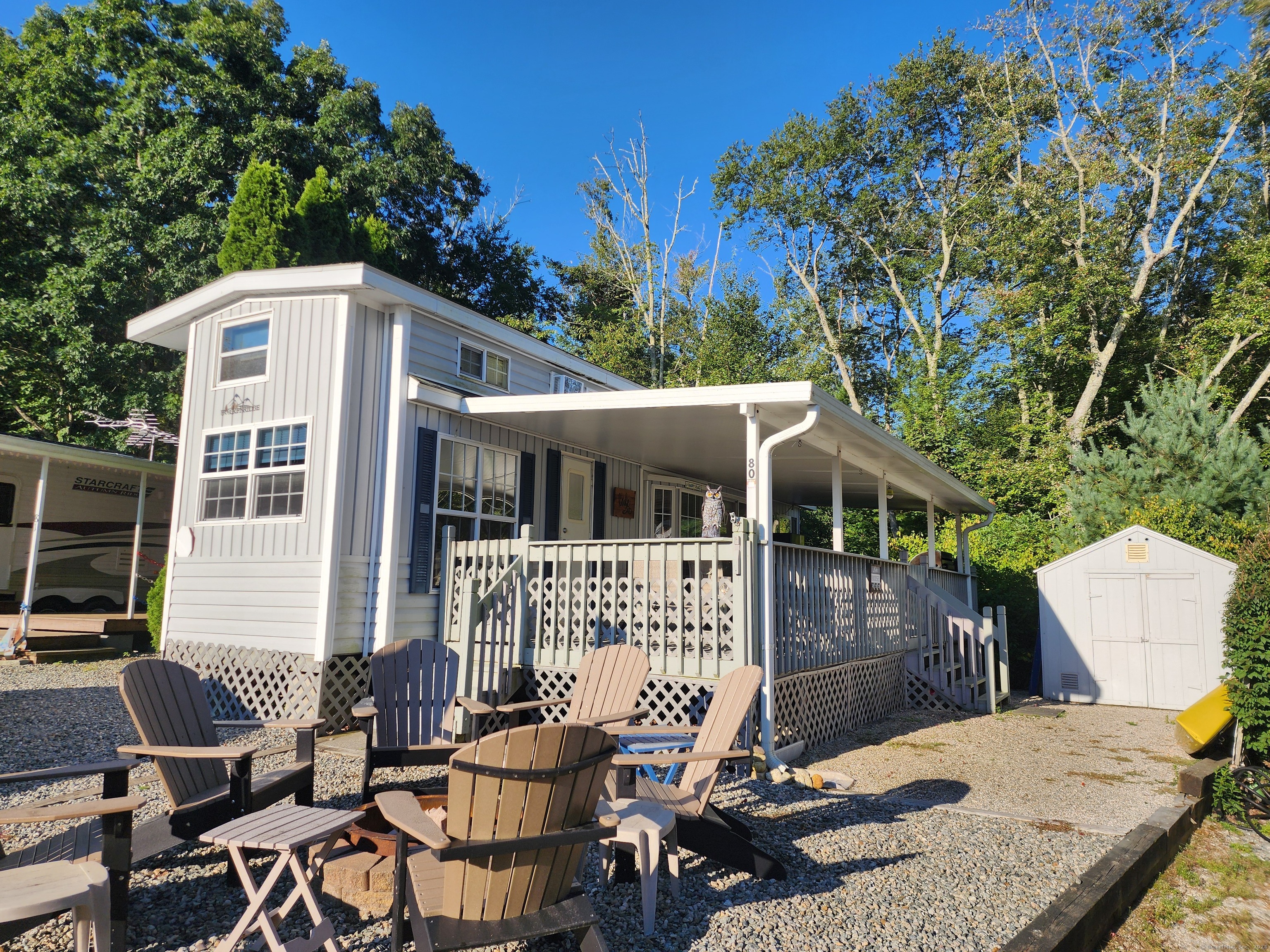 a view of a house with backyard and sitting area