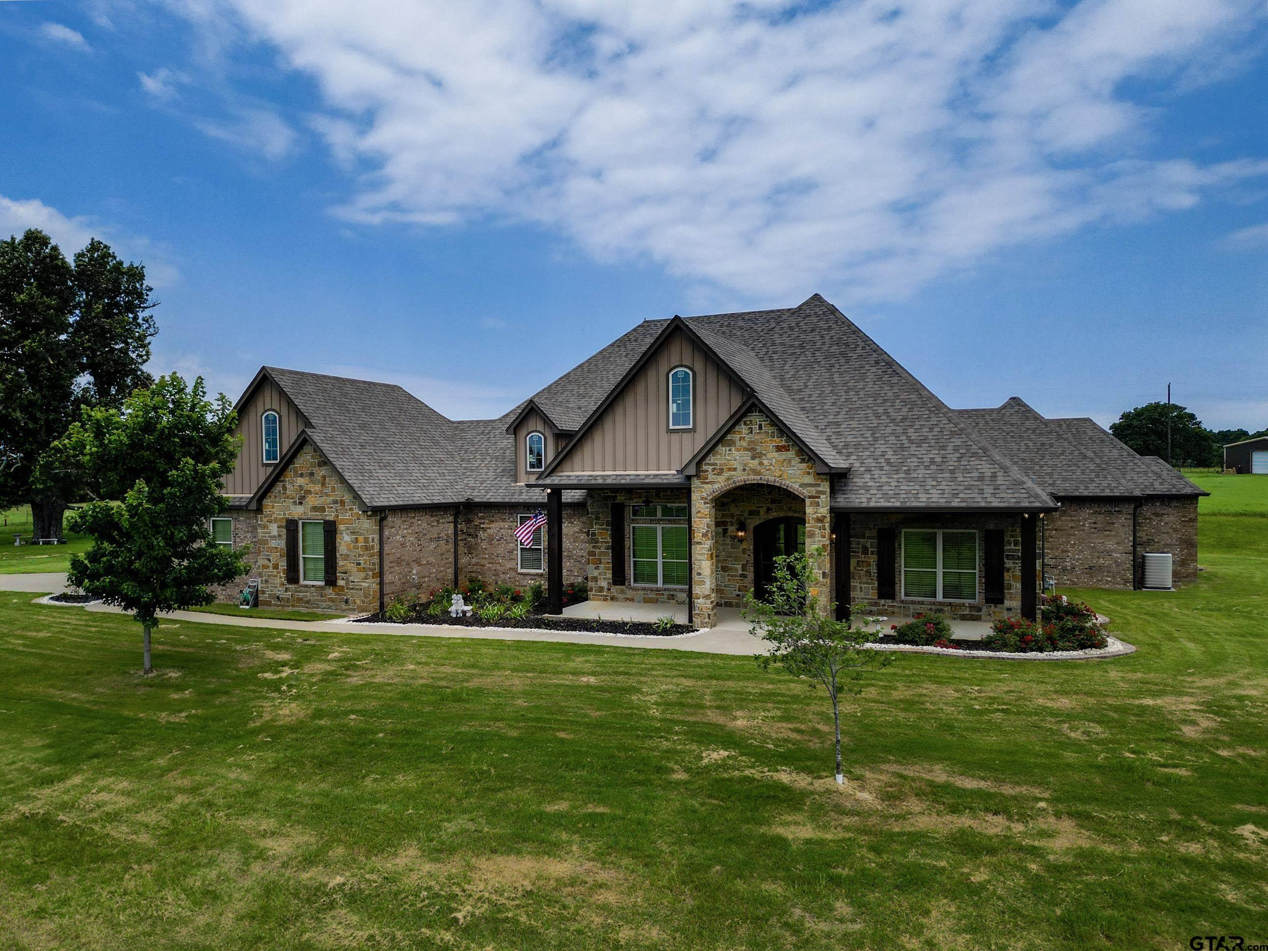 a front view of house with yard and green space