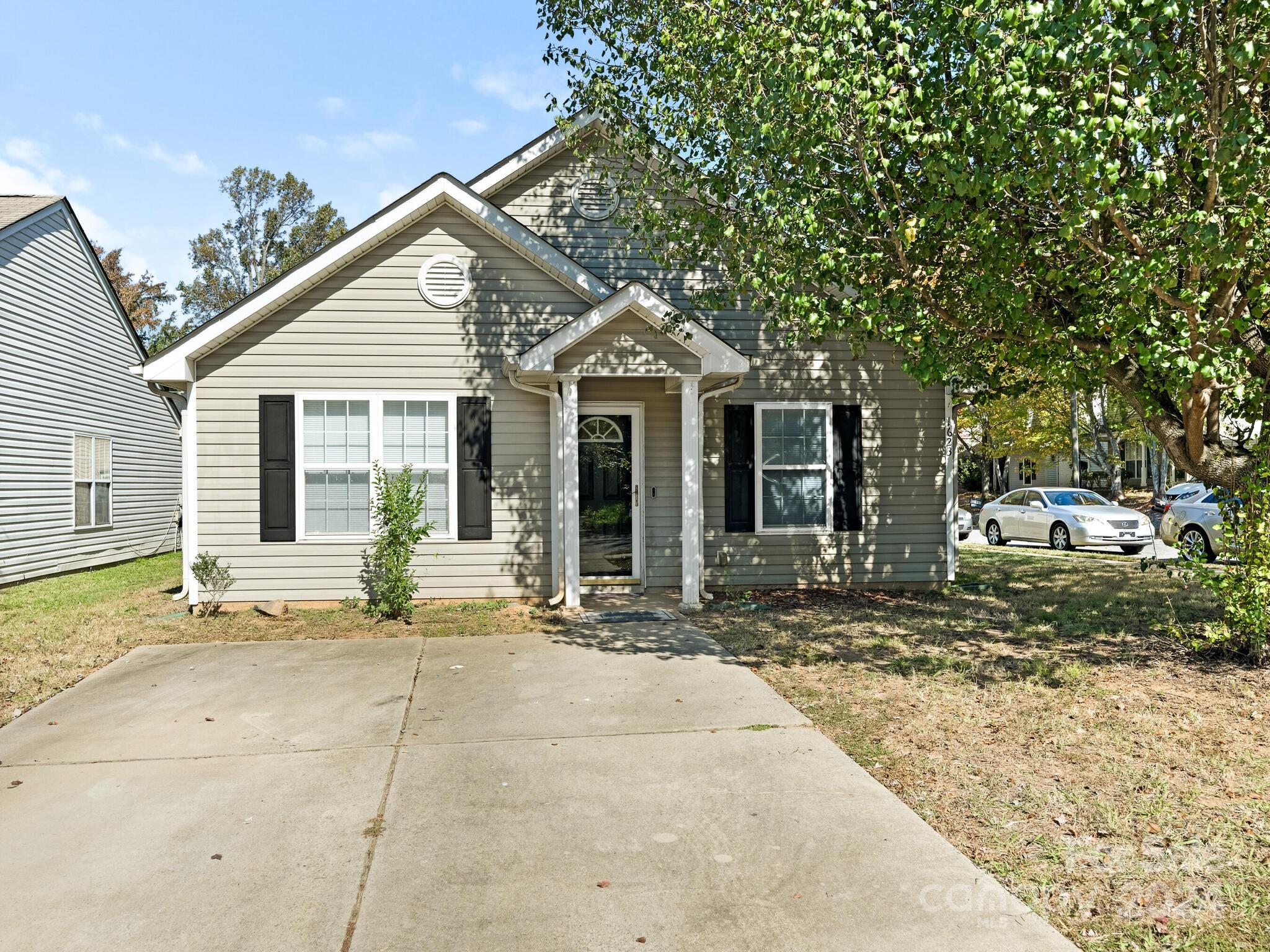 a front view of a house with a garden and patio