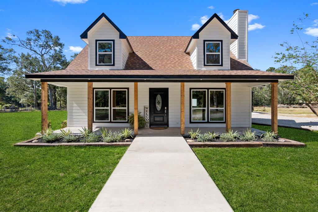 a front view of a house with a yard and porch