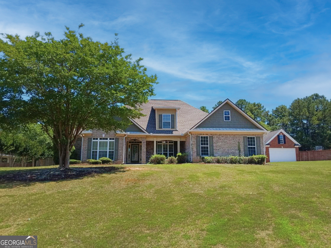 a front view of a house with a yard