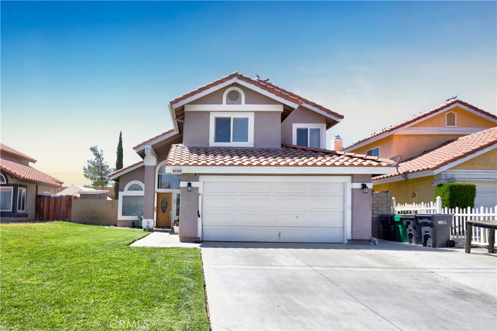 a view of a house with a yard and garage