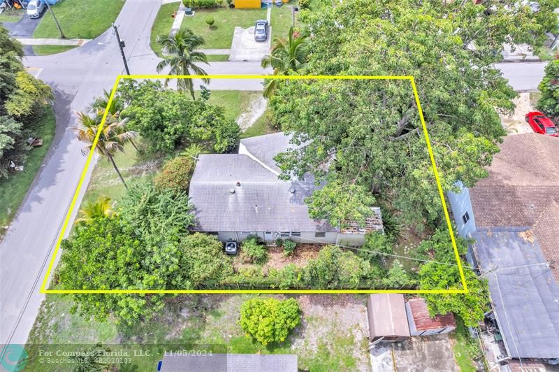 an aerial view of a house with a yard