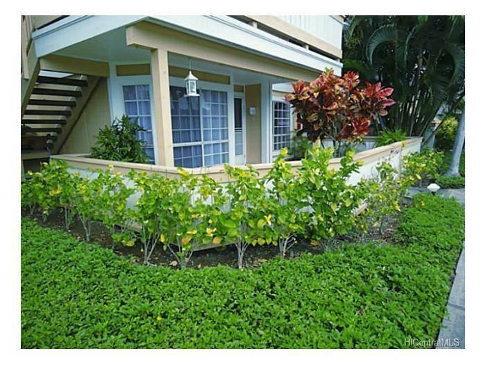 a view of a house with potted plants