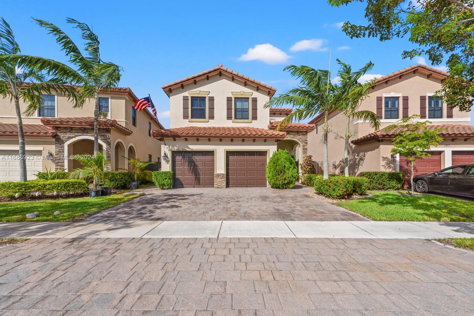 a front view of a residential houses with yard