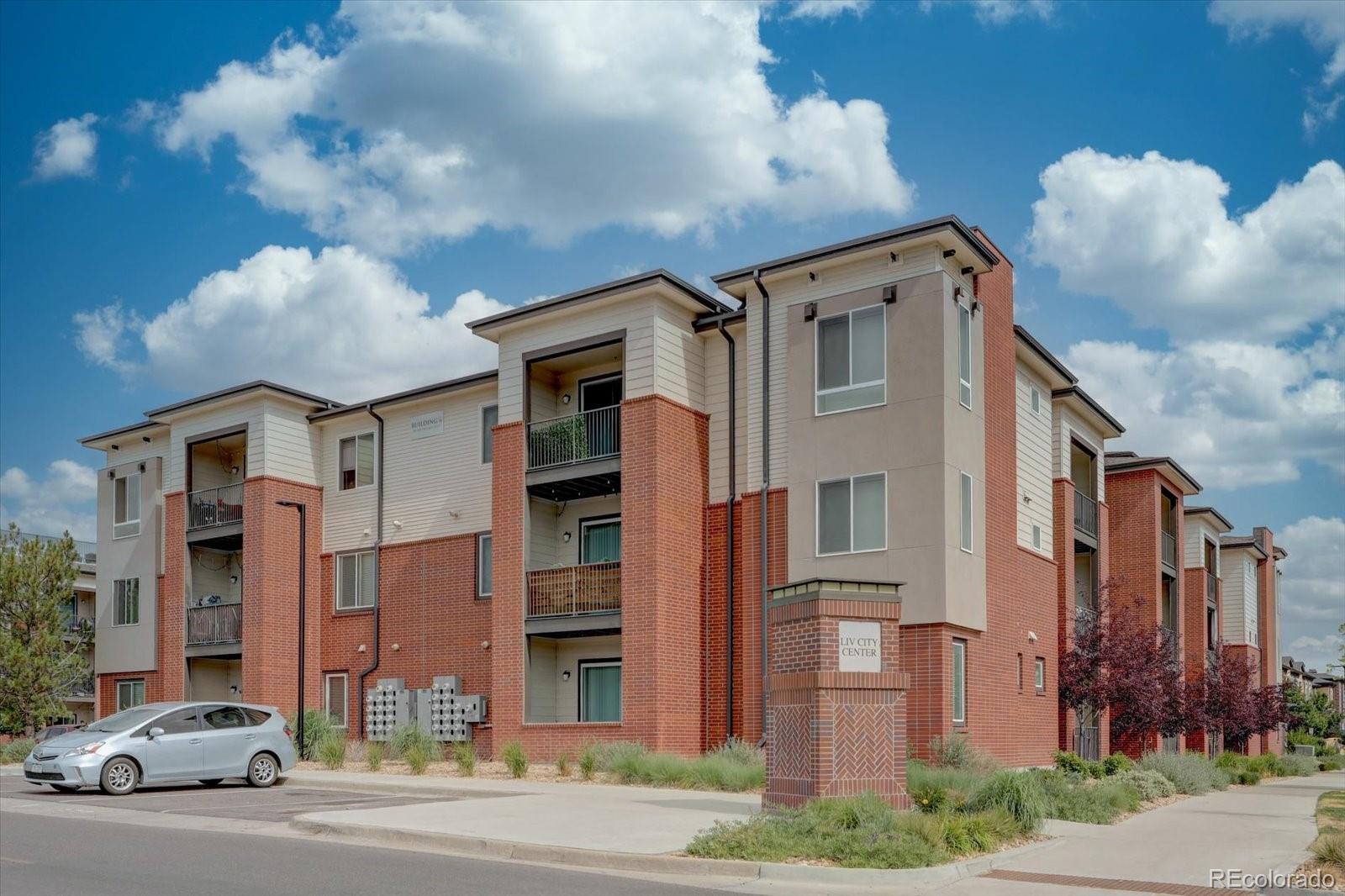 a front view of a residential apartment building with a yard