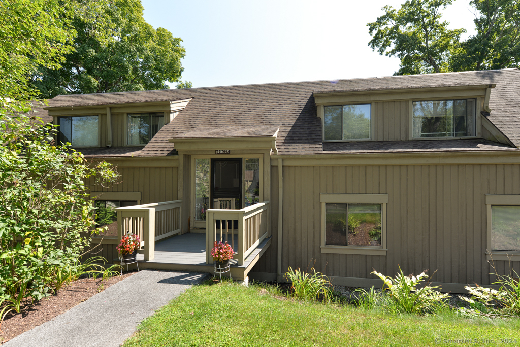 a front view of house with a garden