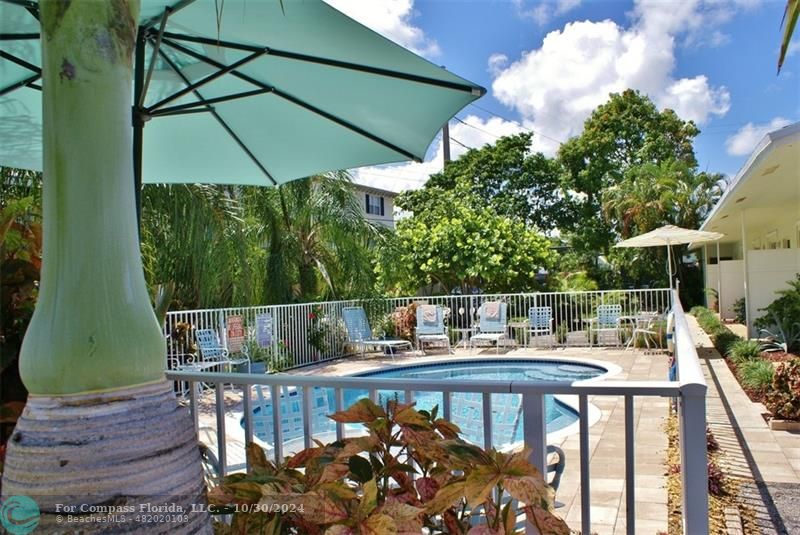 a view of balcony with furniture and umbrella