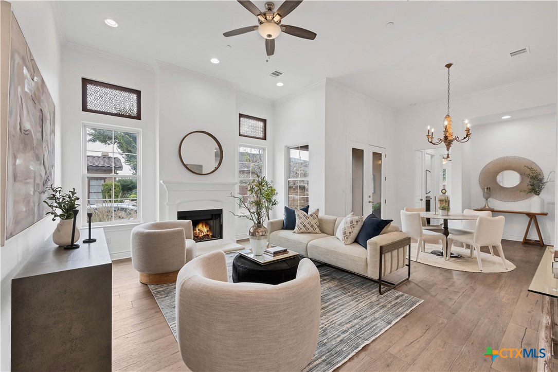 a living room with fireplace furniture and a wooden floor