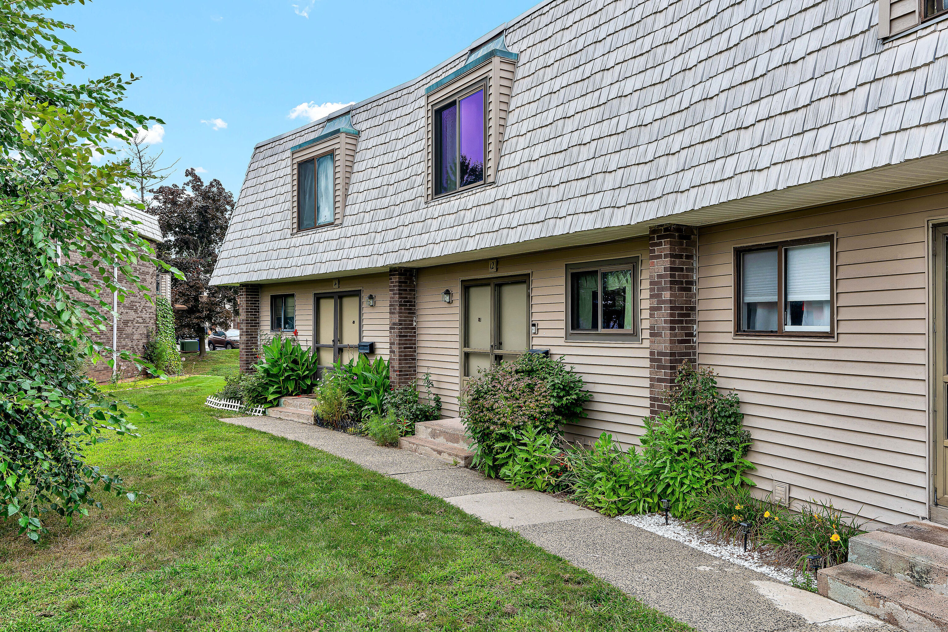 a front view of a house with a yard