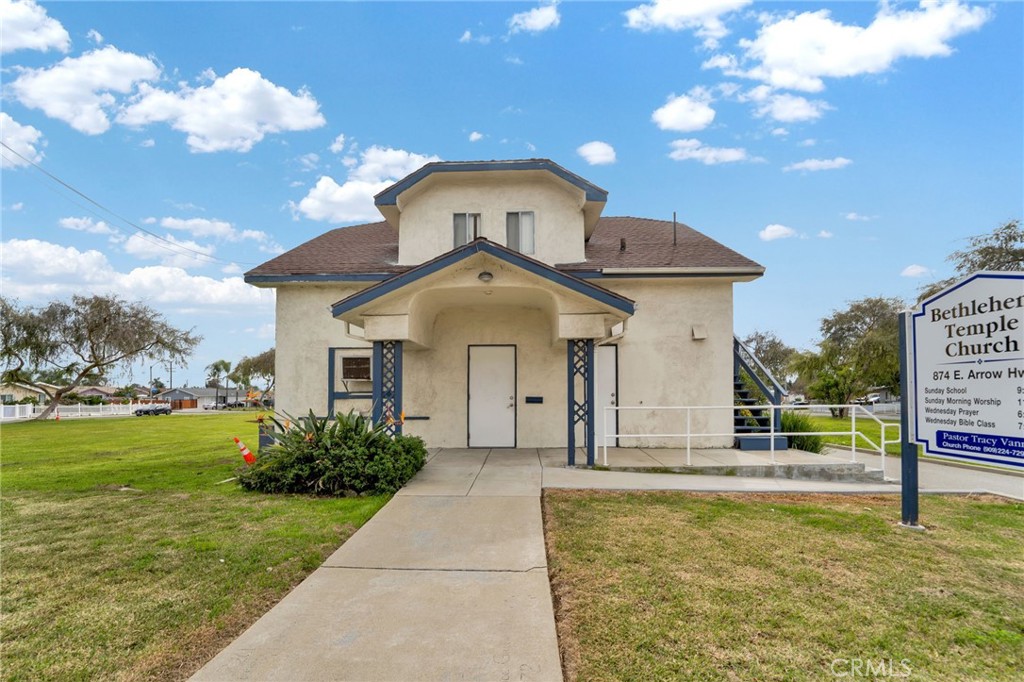 a front view of a house with garden