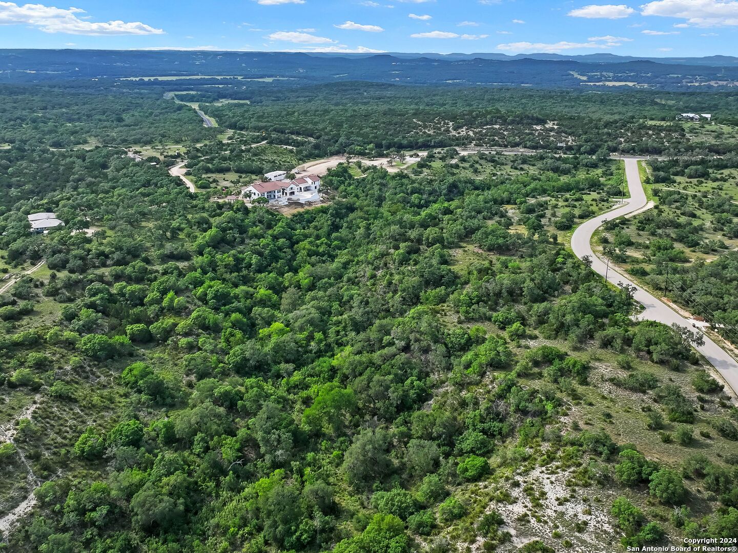 a view of a city with lush green forest