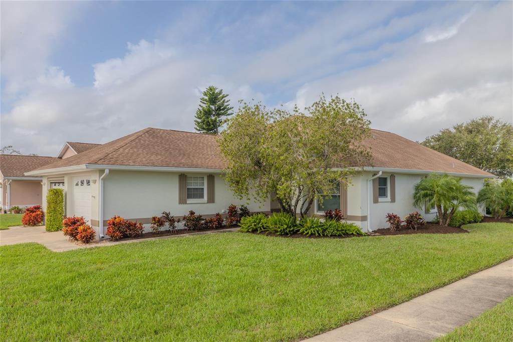 a front view of house with yard and green space