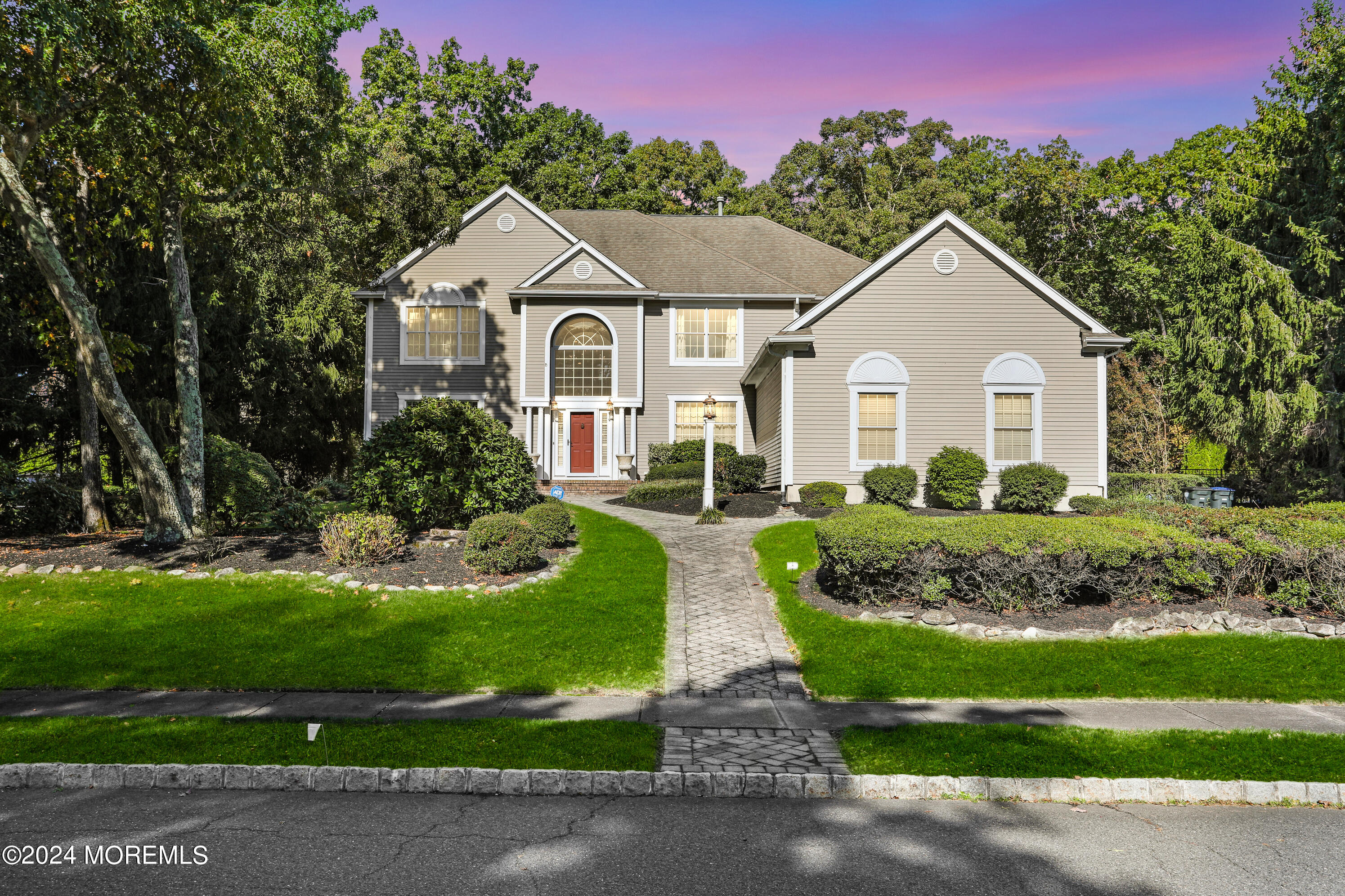 a front view of a house with a garden