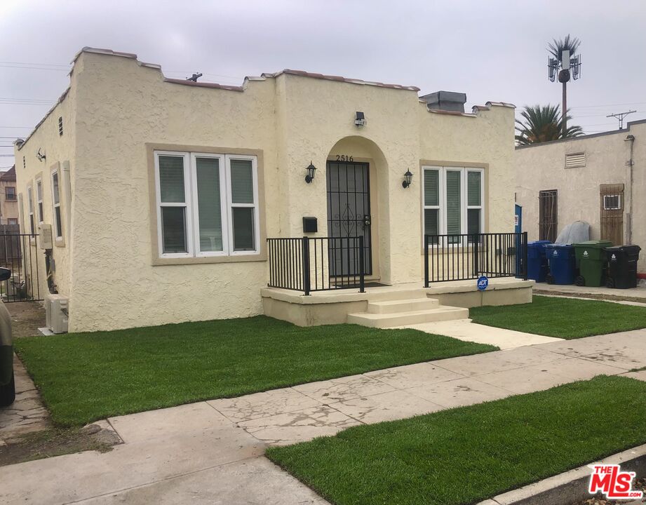 a view of a brick house with a yard