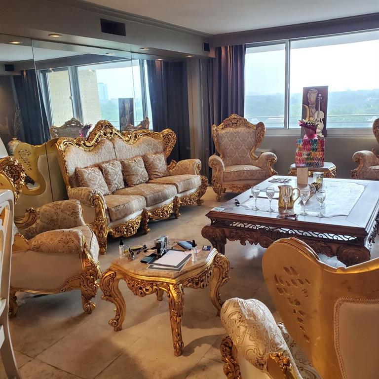 a living room with furniture and floor to ceiling windows