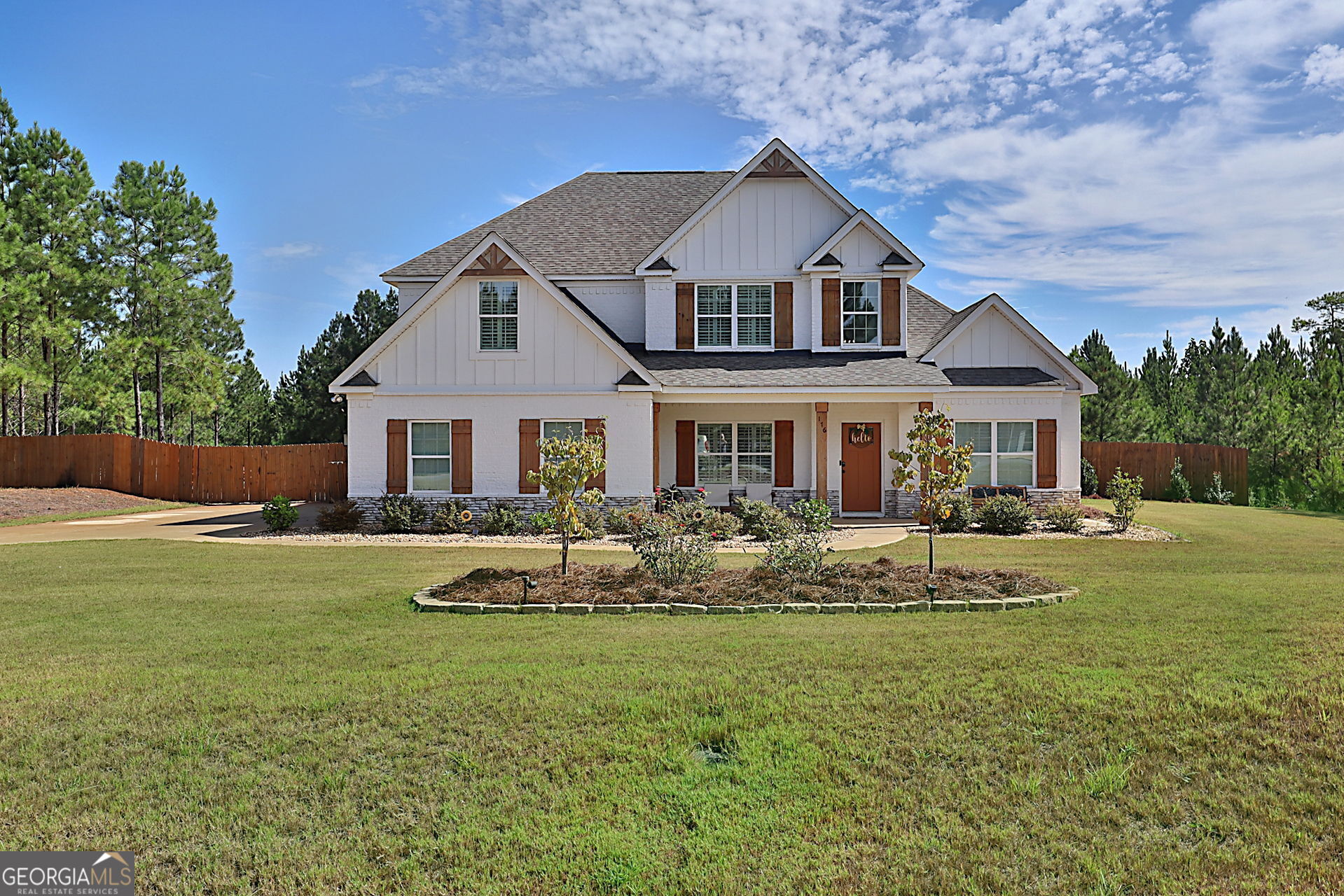 a front view of a house with garden and porch