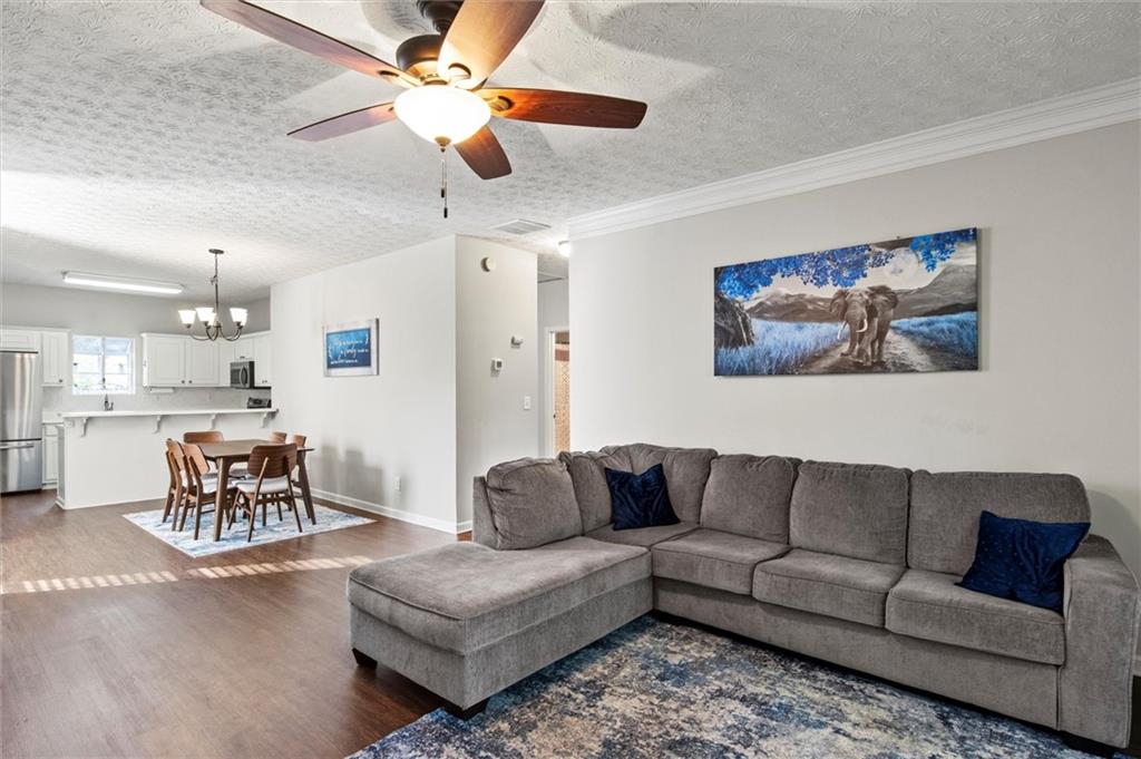 a living room with furniture and kitchen view