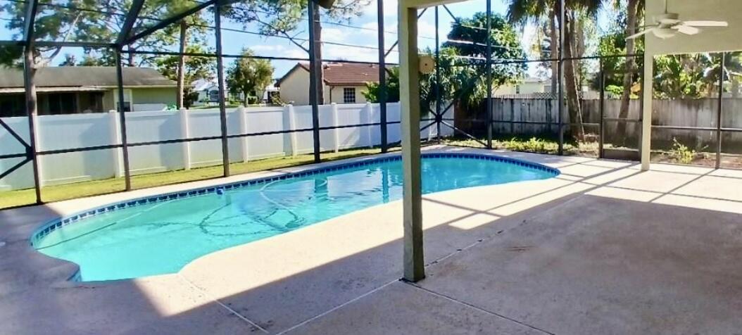 a view of a backyard with swimming pool