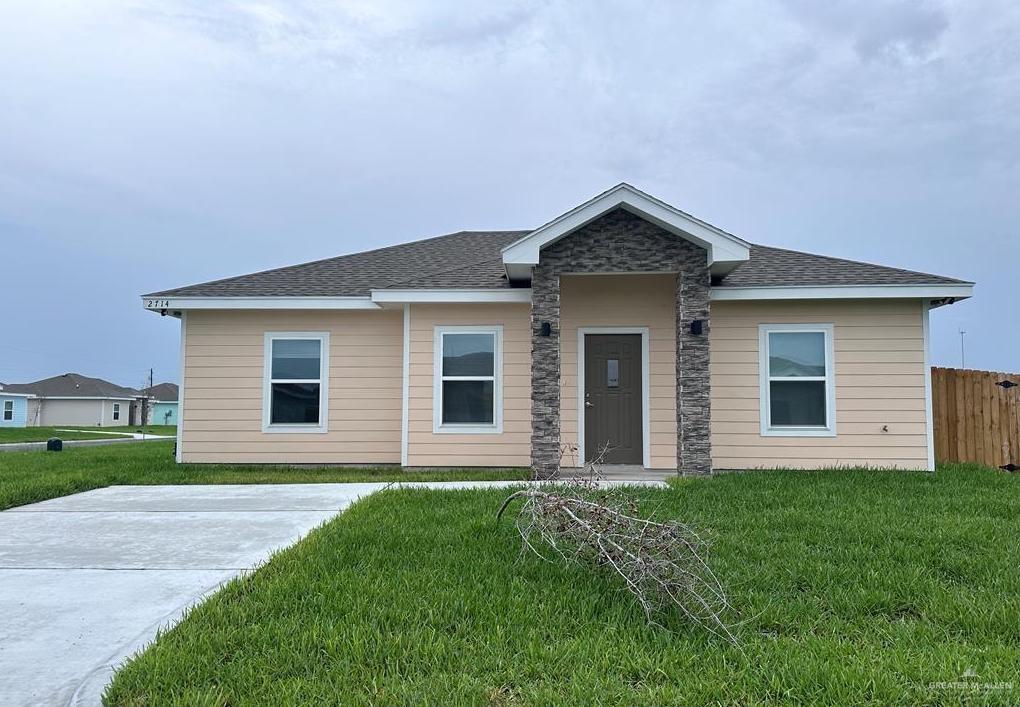 a front view of house with yard and green space