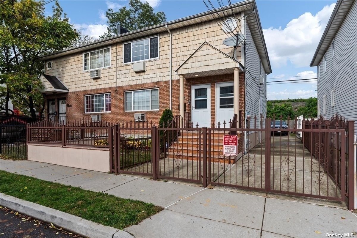 a view of a house with wooden fence