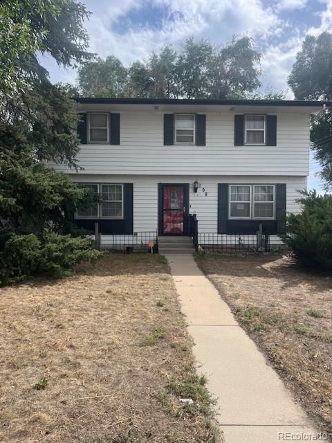 a front view of a house with yard