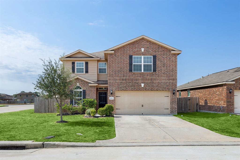 a front view of a house with a yard and garage