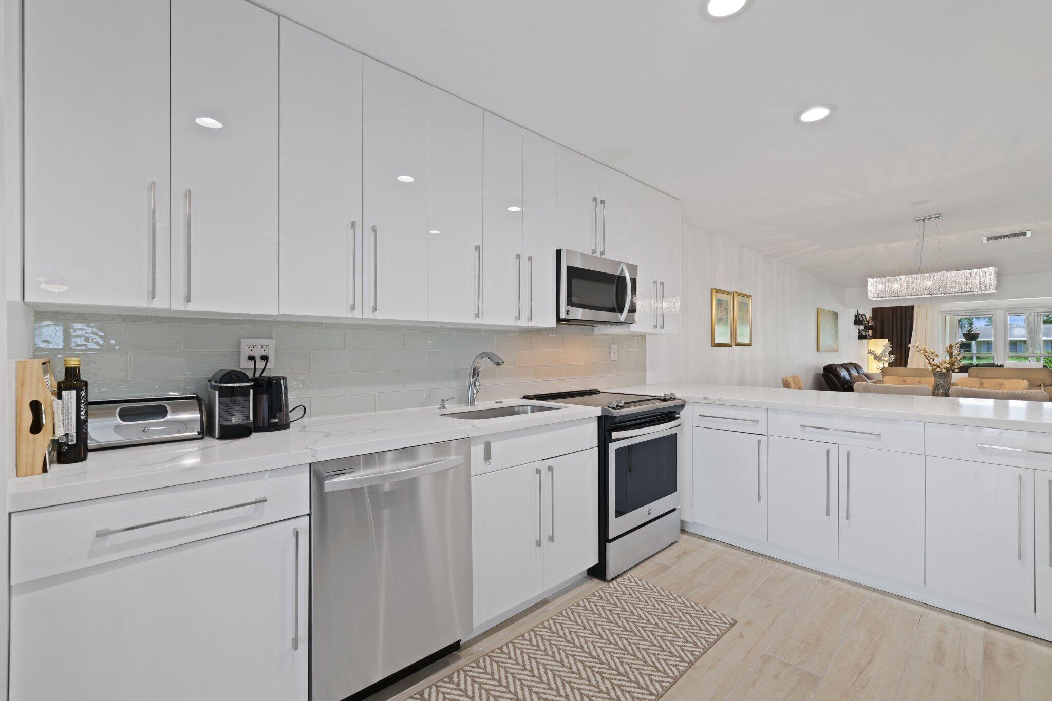 a kitchen with cabinets stainless steel appliances and a counter space