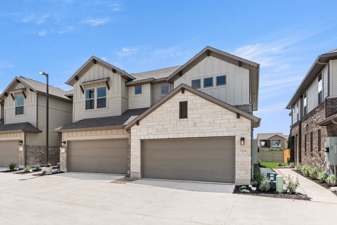 a front view of a house with a garage