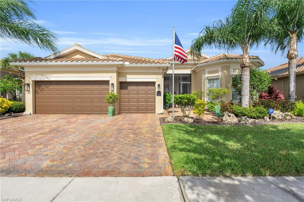 a front view of a house with a yard and garage