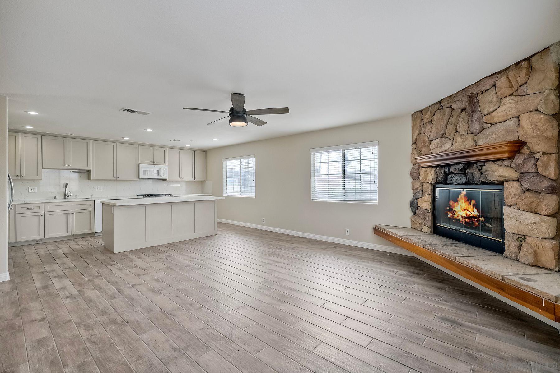 a view of kitchen with cabinets and wooden floor