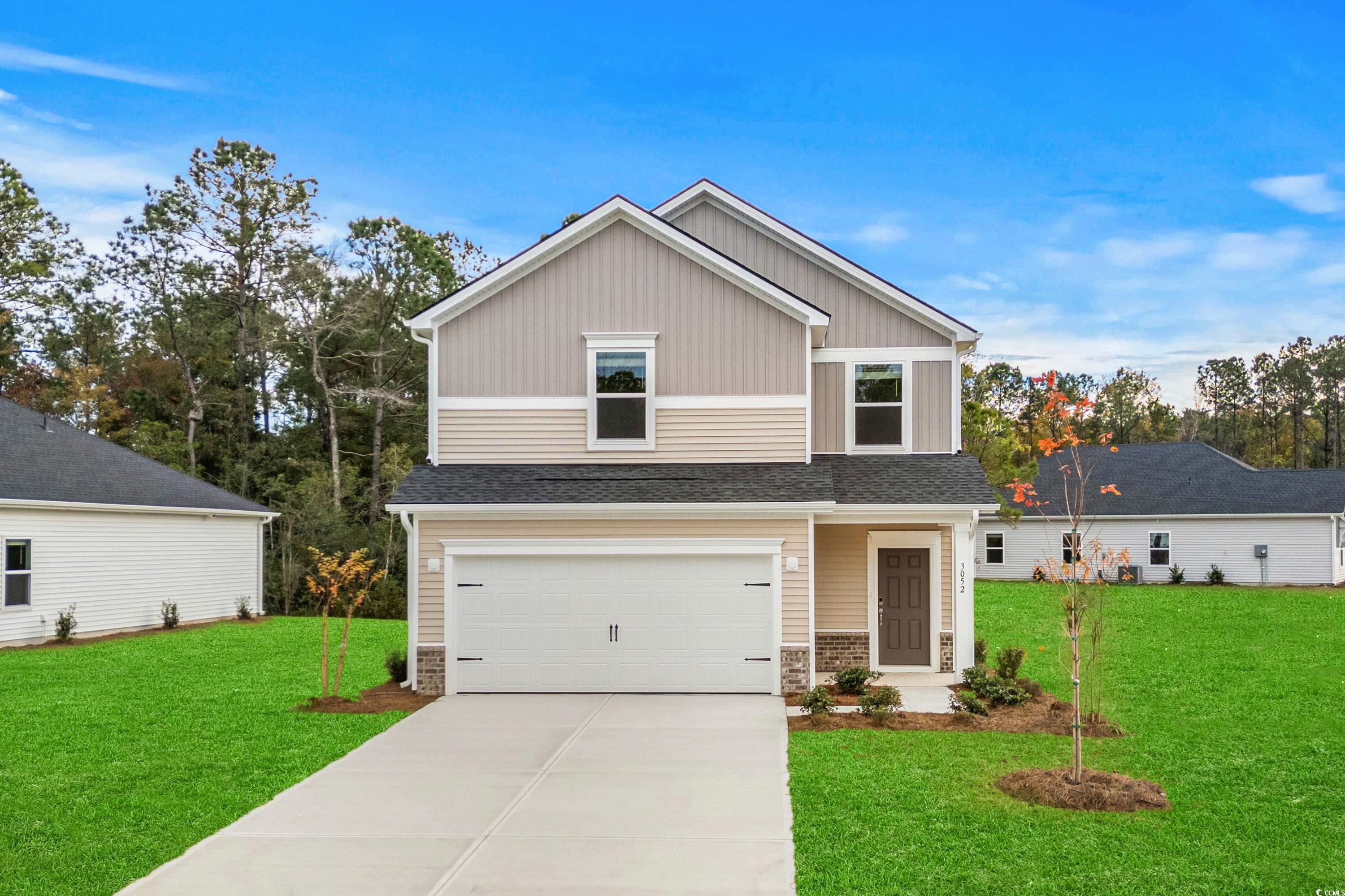 View of front of house featuring a garage and a fr