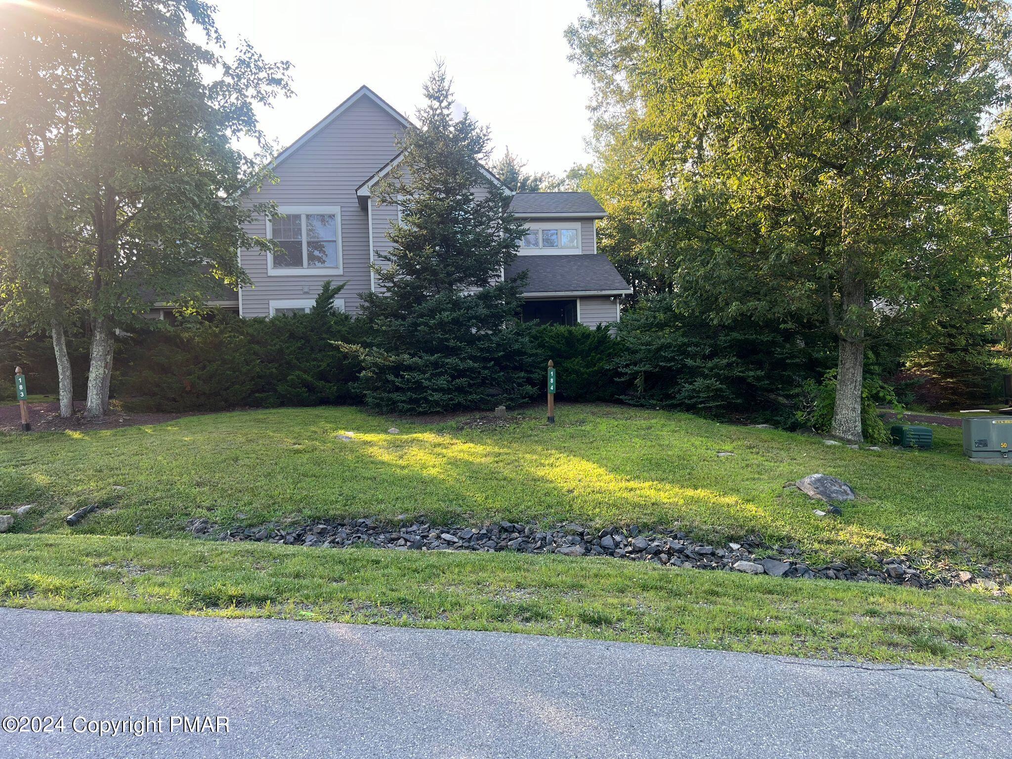 a view of a house with a backyard and a garden