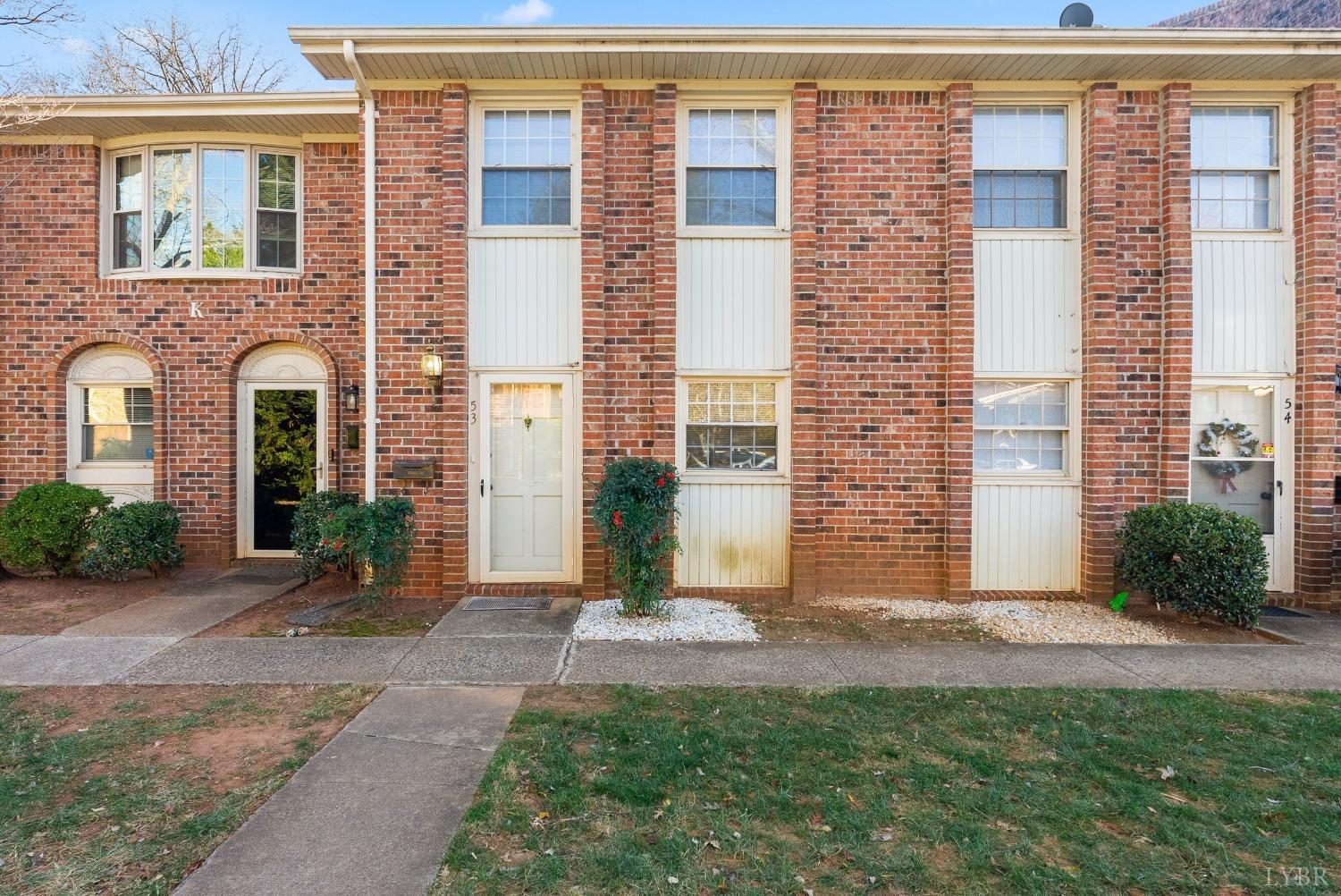 a view of a brick building next to a yard