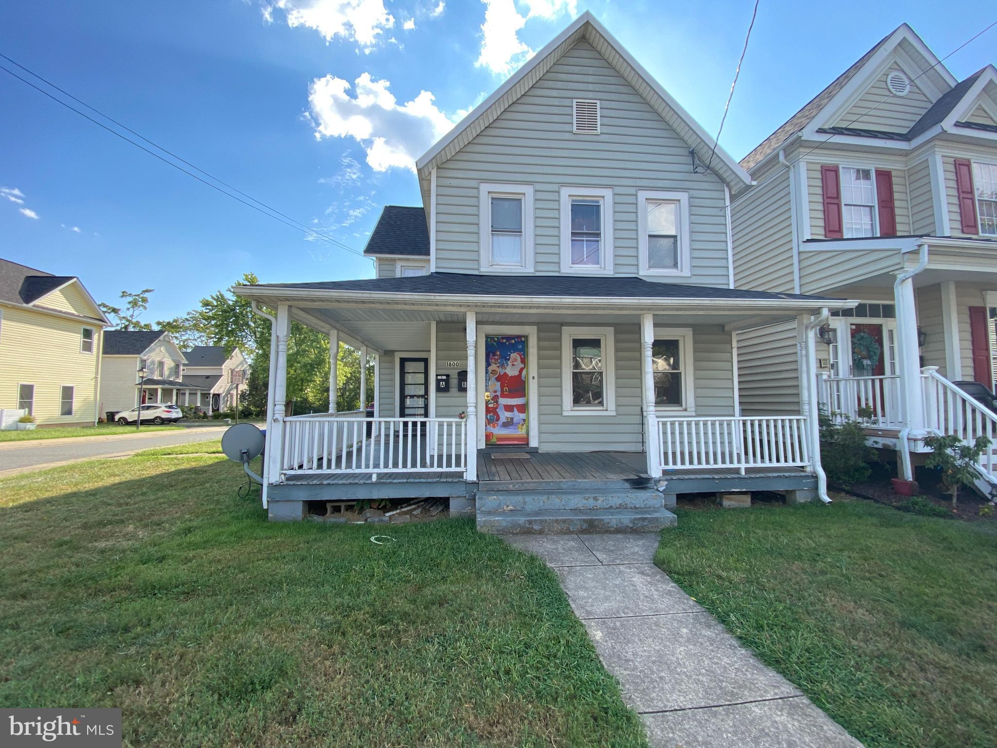 a view of a house with a yard and deck