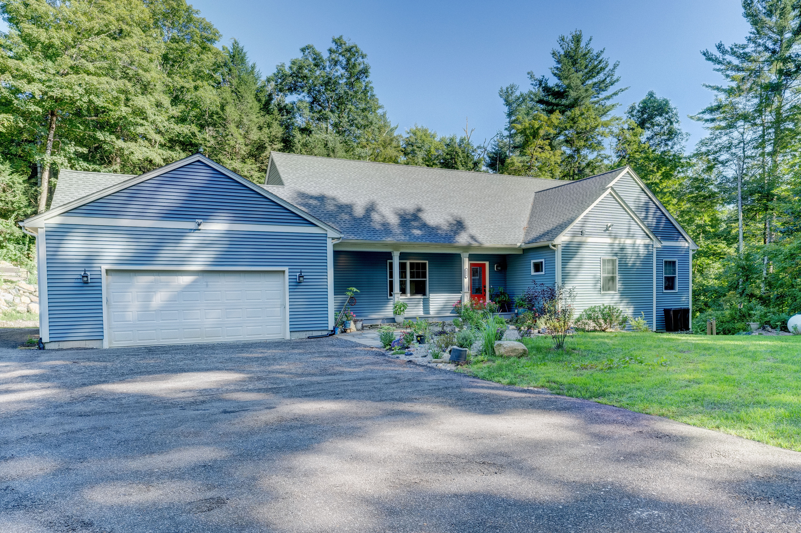 a front view of a house with a garden and yard