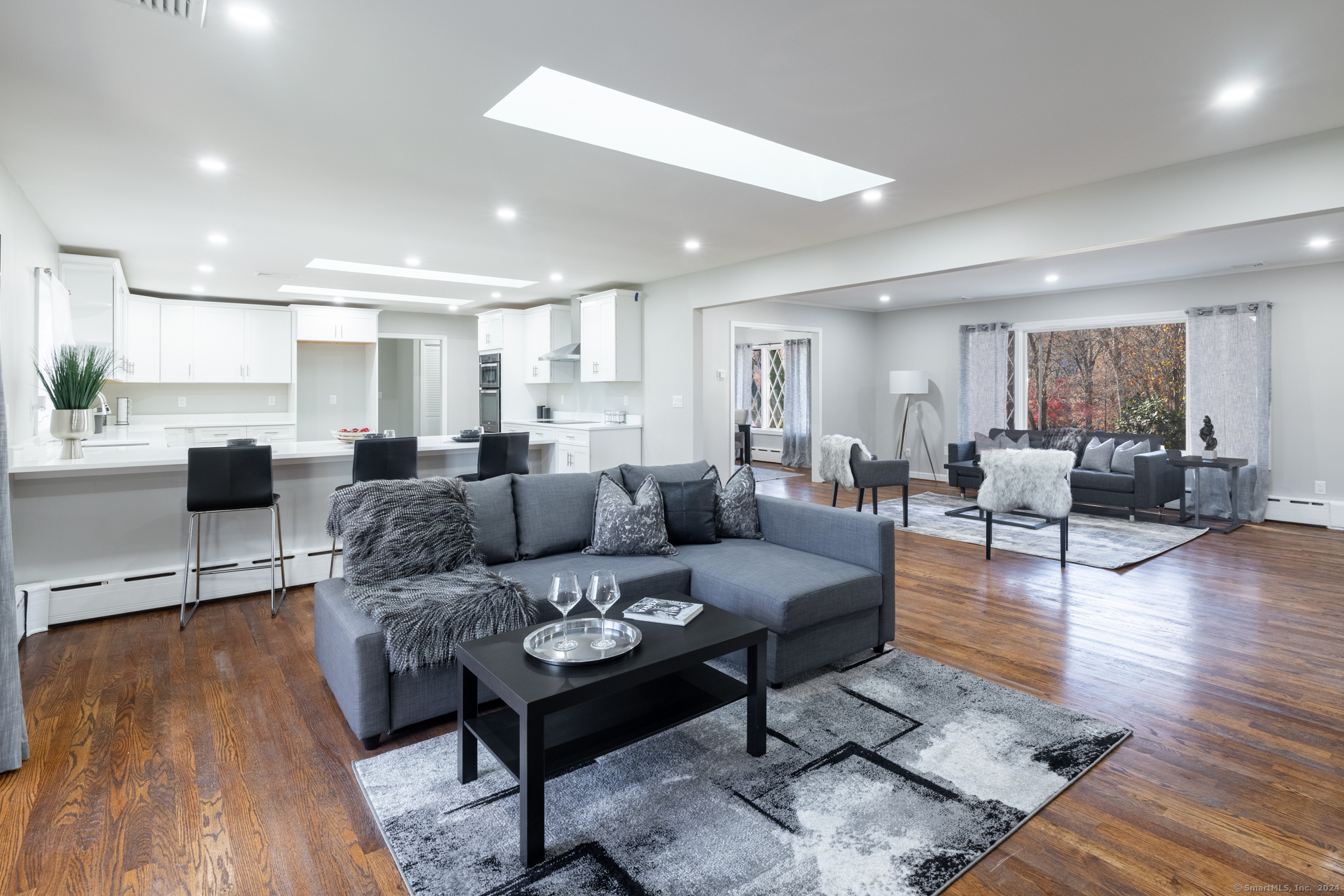 a living room with furniture and wooden floor