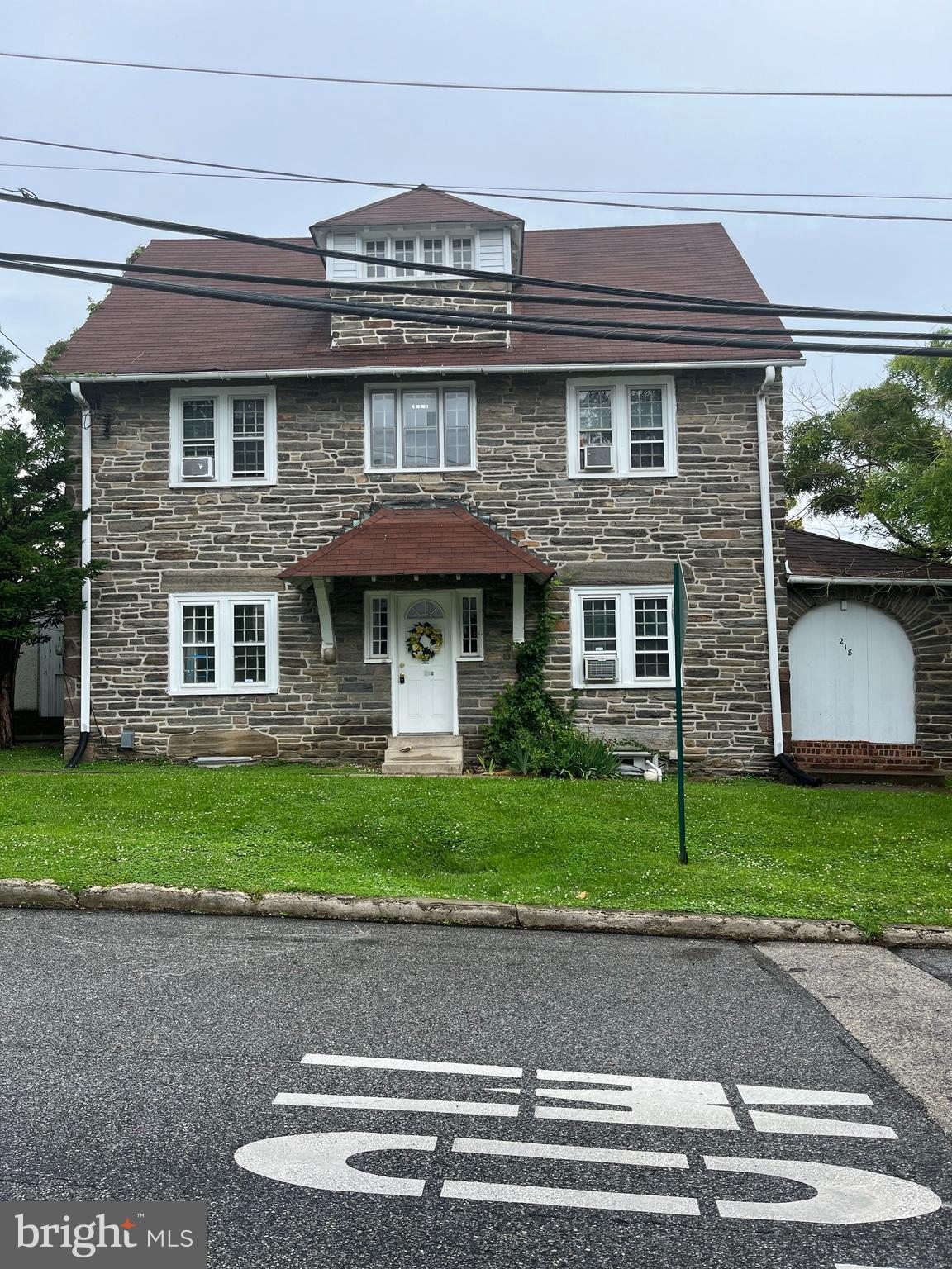 a front view of a house with a yard and a garage