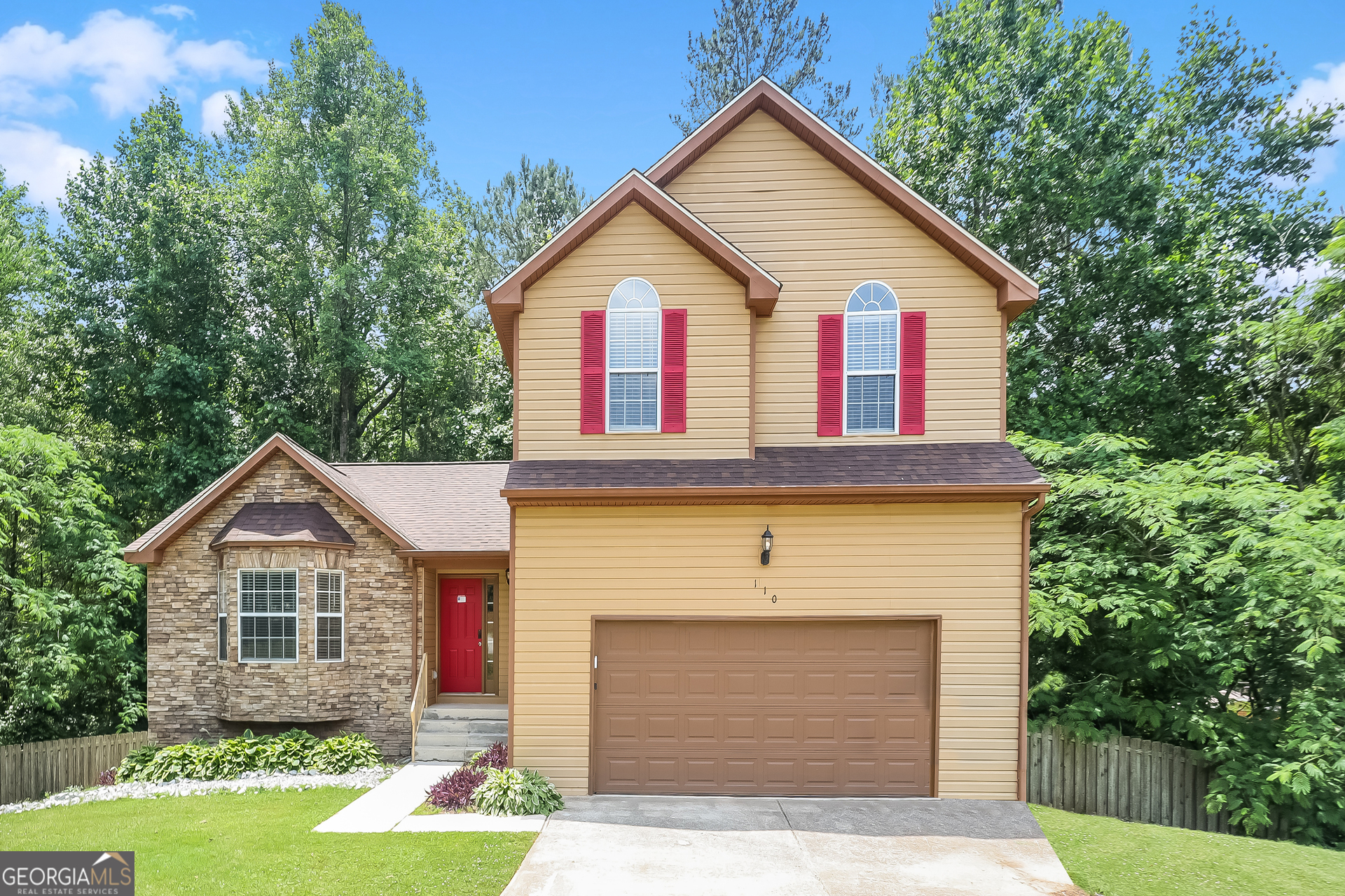 a front view of a house with a yard