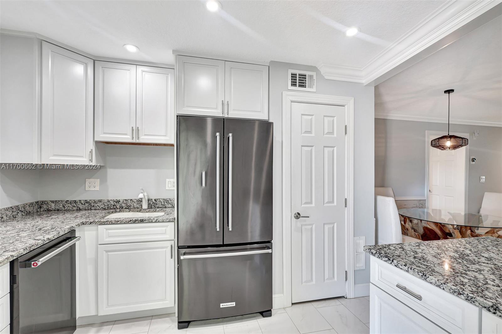 a kitchen with a refrigerator and a sink