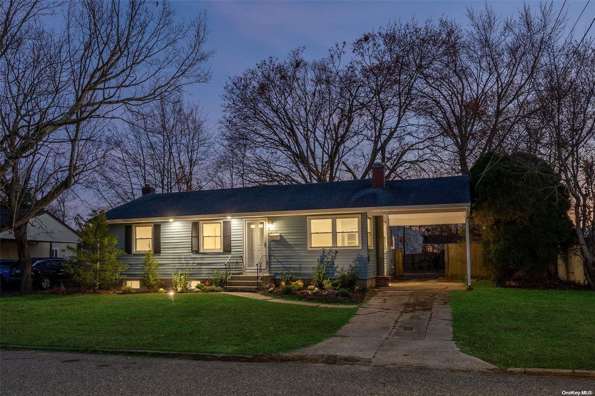 a front view of a house with a yard and green space