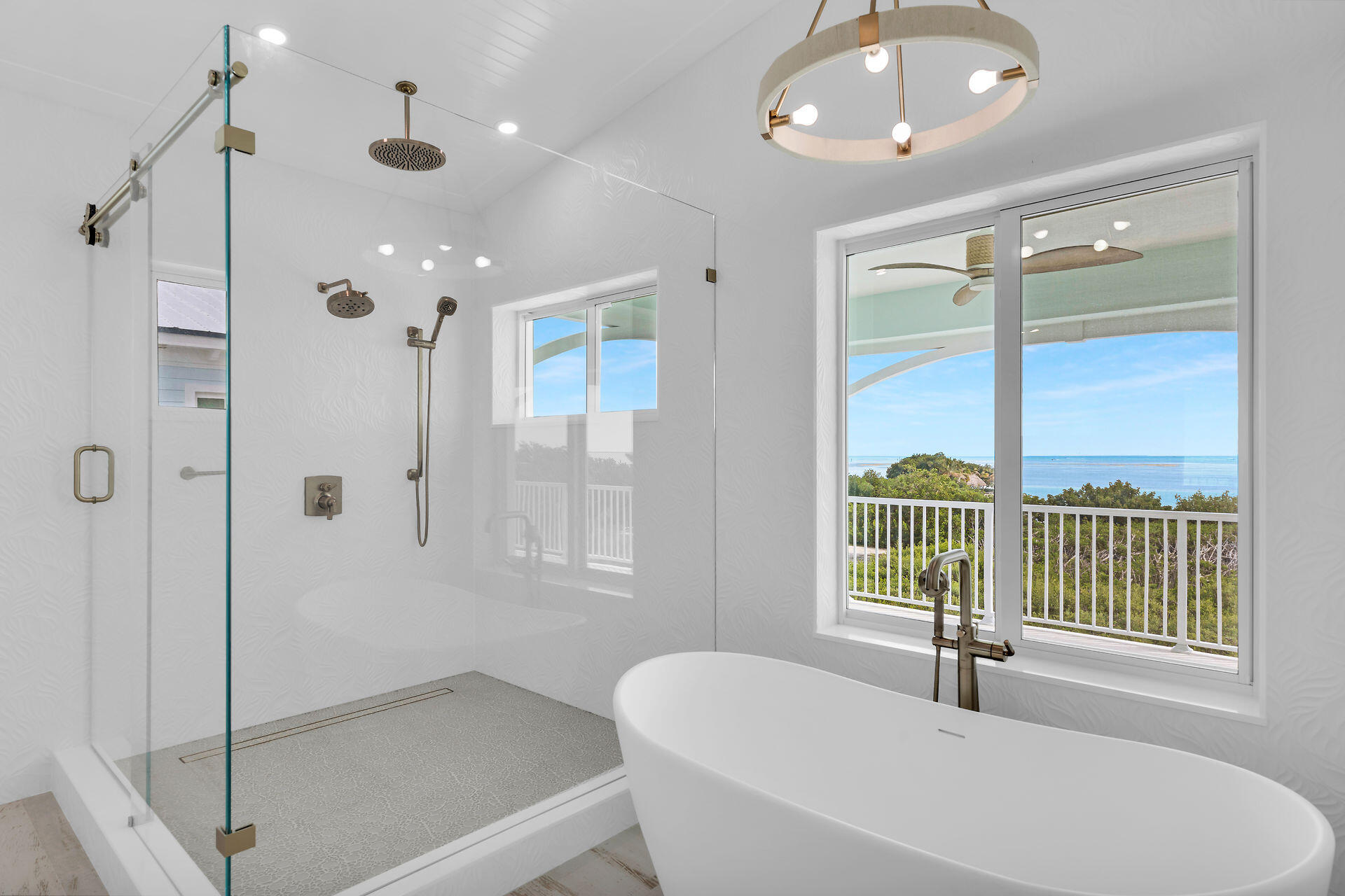 a spacious bathroom with a tub shower and windows