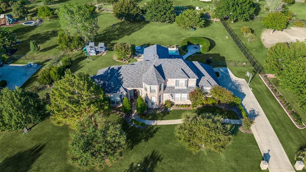 an aerial view of a house with outdoor space and a lake view